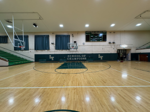 Custom green wall padding printed with School of Champions text and LT logos in Lane Tech College Prep gym.